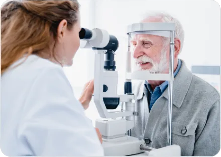 Senior patient having his eyes examined at a slit lamp