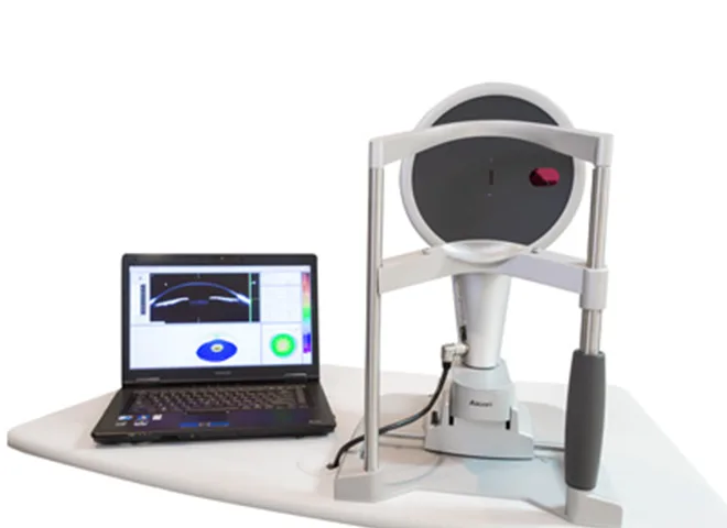 Anterior segment analysis instrument with a laptop showing corneal cross-section maps